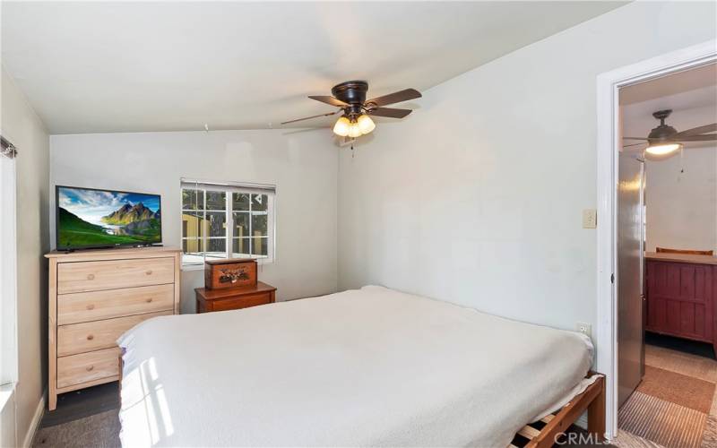 Bedroom 1 with view of the pond and peak-a-boo of the city.