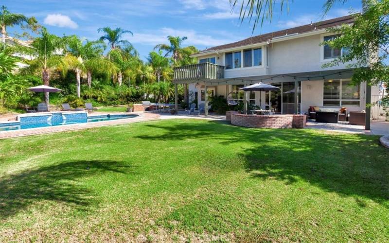 Lush lawn overlooks swimming pool