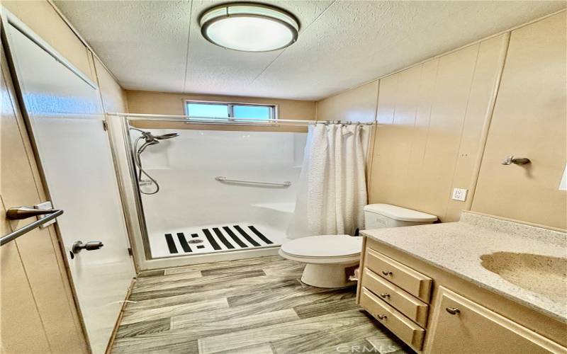 Guest bathroom with step in shower This bathroom connects to the guest bedroom