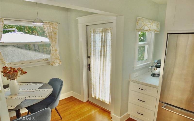 Another perspective showcasing the picture window dining area alongside the beautiful cabinetry.