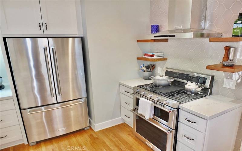 Another view of the spacious French door refrigerator, complemented by exquisite cabinetry that offers ample storage