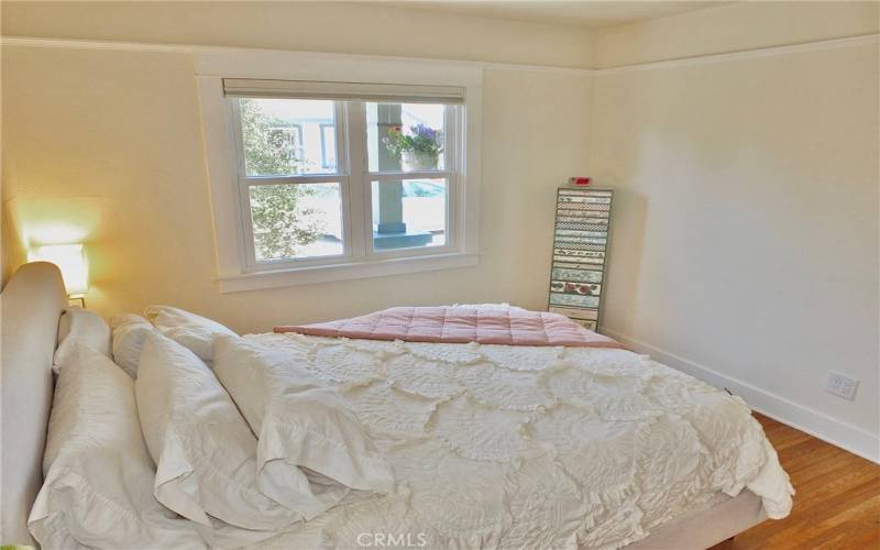 Another perspective of the serene bedroom, inviting relaxation and comfort

