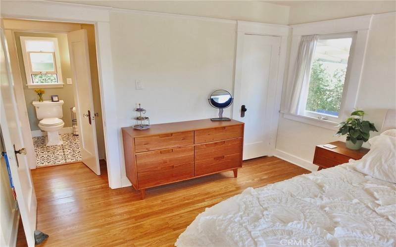 Another view of the bedroom, showcasing an additional window and the closet door. Just across the hall, you'll find the beautifully remodeled bathroom

