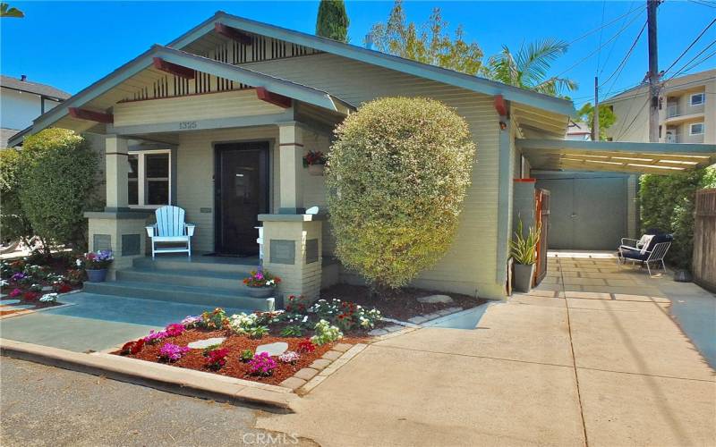 Extended driveway leading to a single-car garage, offering both convenience and a welcoming arrival.