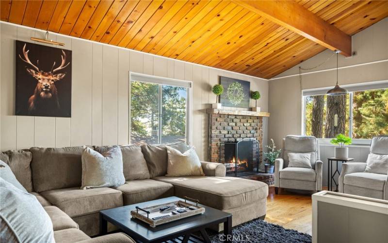 Living room with knotty pine open beam ceiling.