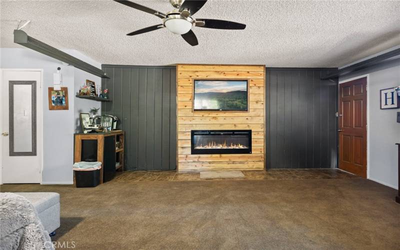 Guest room with custom wall-built in electric fireplace.