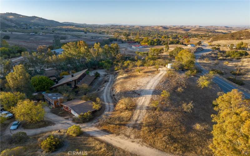 Aerial view of the back of the property showing detached studio and garage