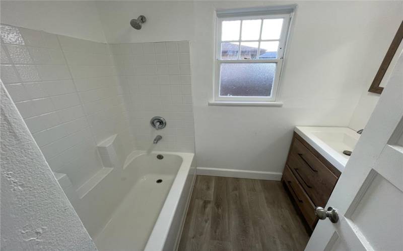 Secondary bathroom located between kitchen and bonus room. Window faces east.