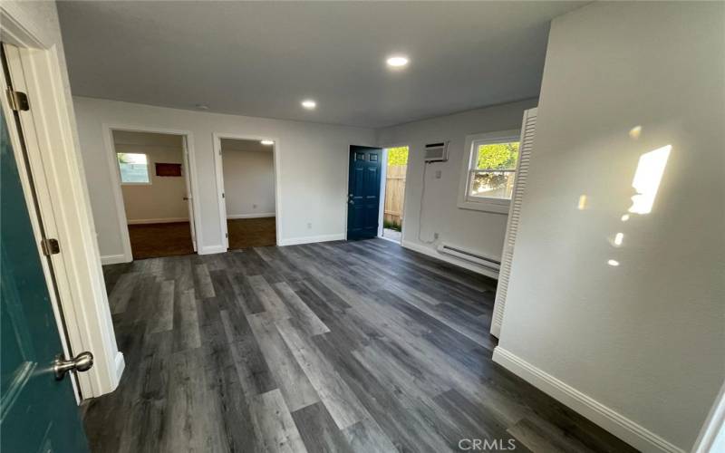 Back house entrance. Kitchen and bath to the left, 2 bedrooms straight ahead, door to backyard to the right.