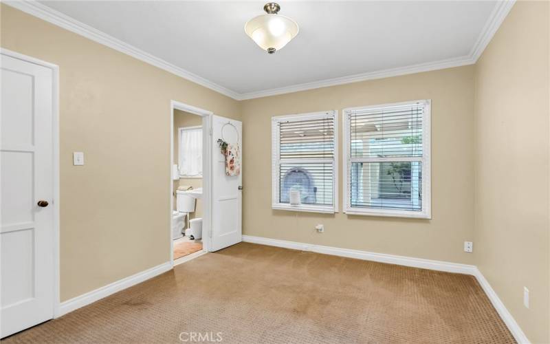 Office with closet off the living room with attached 3/4 bathroom -- this room could easily be Bedroom #4 by simply adding a wall or louvered doors.