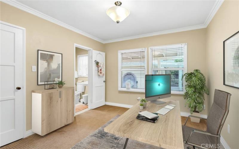 Office with closet off the living room with attached 3/4 bathroom -- this room could easily be Bedroom #4 by simply adding a wall or louvered doors (virtually staged).