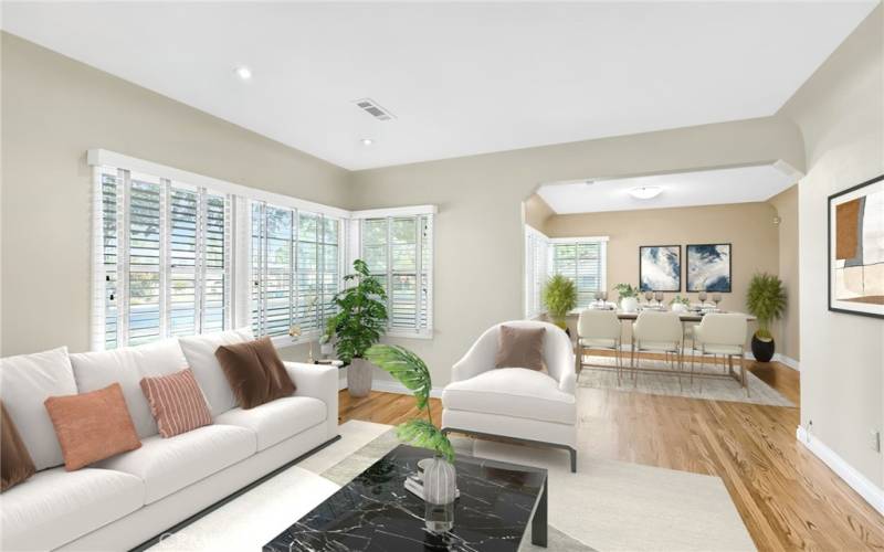 Alternate view of living room with view into the formal dining room (virtually staged)