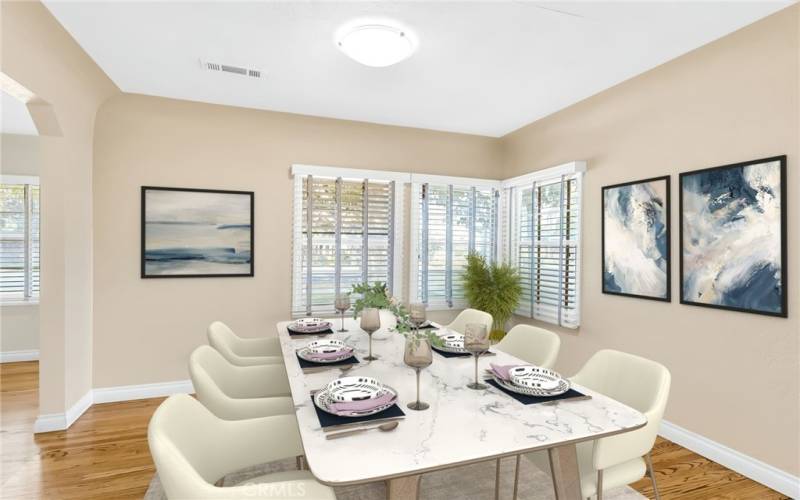 Formal dining room with hardwood flooring and lots of natural light (virtually staged).