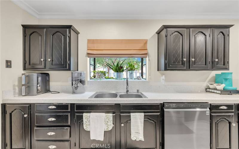 Remodeled kitchen with dishwasher and quartz countertops and lots of cabinetry throughout.