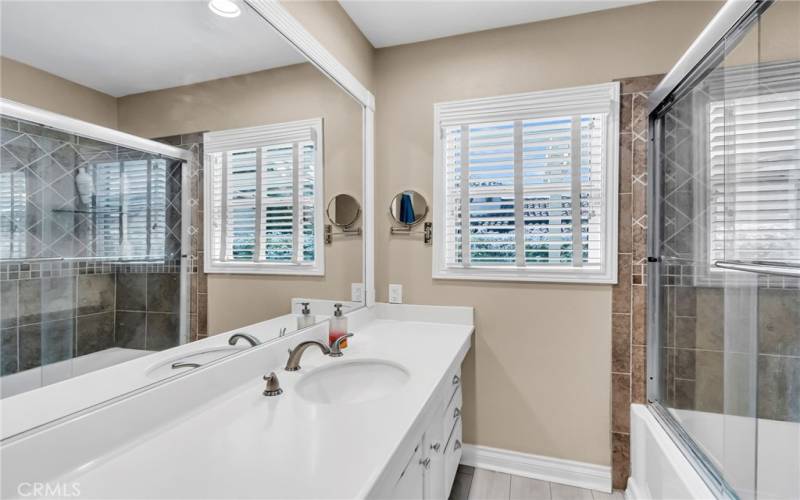 Lovely remodeled hallway bathroom with shower in tub, shared by Bedrooms #2 and #3.