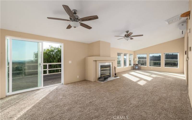 Main living area with sliding door access to deck