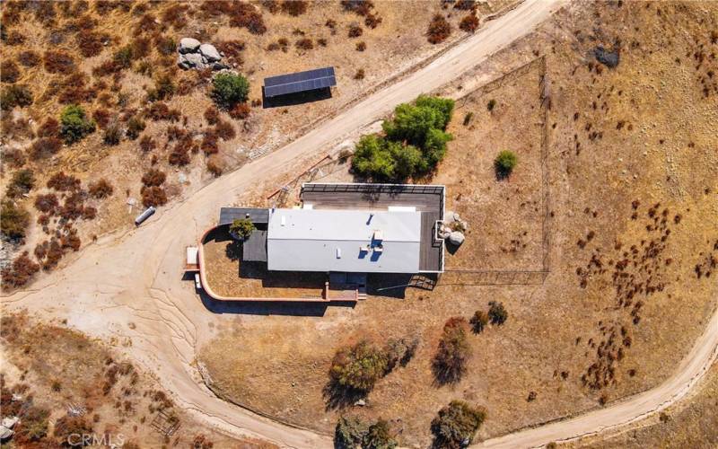 Ariel view of home showing private fenced backyard, fenced front yard and wrap around deck.