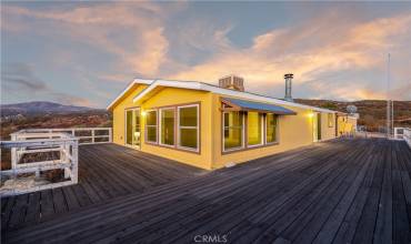 Home at sunset with wrap around deck with panoramic views