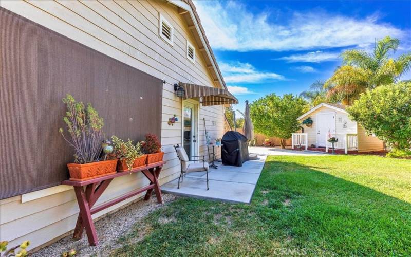 Back yard with patio, lawn area and custom shed.  Would make a great playhouse.