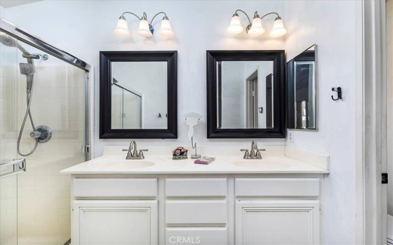 Primary bath with upgraded lighting, fixtures and mirrors.  Dual basins.