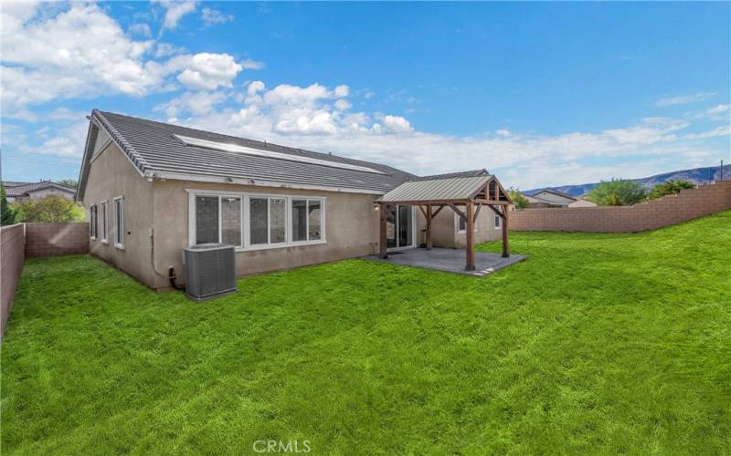 Virtually staged side yard and backyard grass