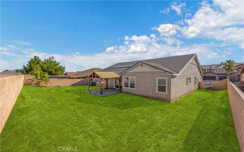 Virtually staged backyard and side yard grass