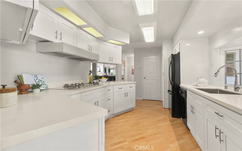 Remodeled kitchen with quartz countertops and included appliances.