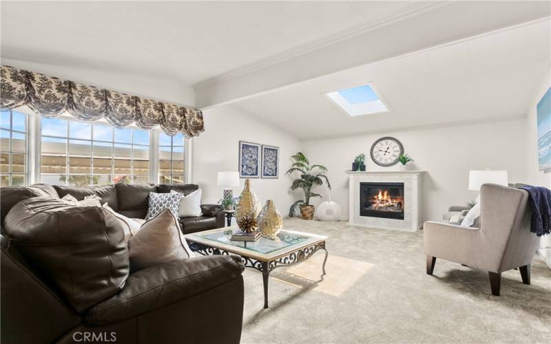 This home features a spacious living room bathed in natural light from the bay window and skylight.