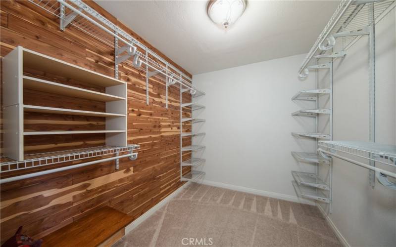 Walk in closet in primary bedroom.