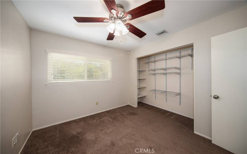 Nice sized bedroom with ceiling fan.