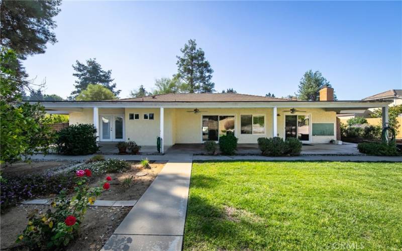 View of house from the backyard.  Covered patio expands the length of the house.