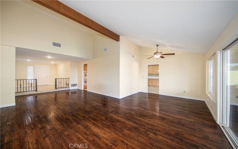 Living room with vaulted ceilings and eating area.