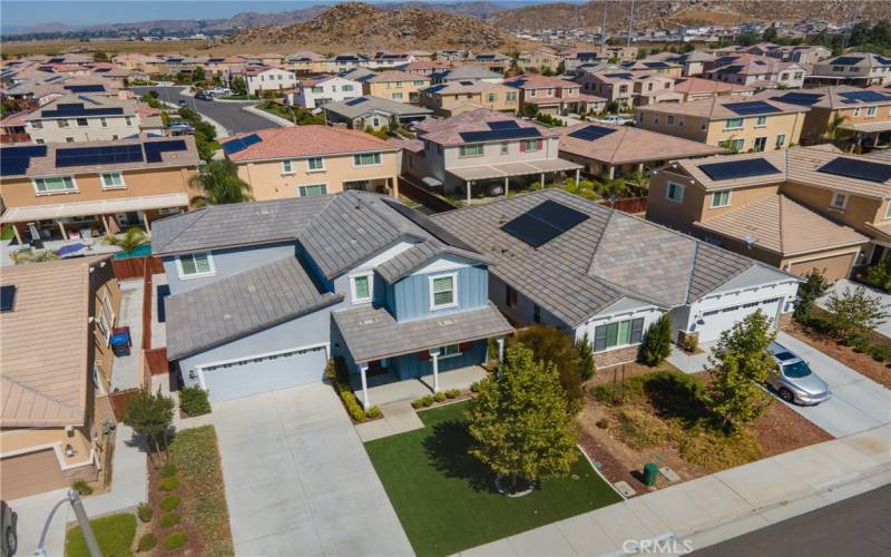 Drone view of the front of the home. Artificial turf in the front yard for easy maintenance