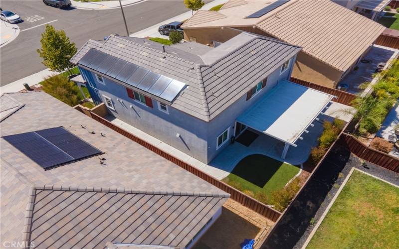 Drone view of the side of the home showing the solar panels