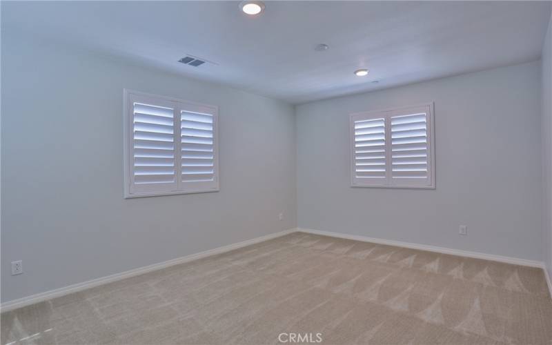 Primary bedroom: Upstairs, carpet, plantation shutters