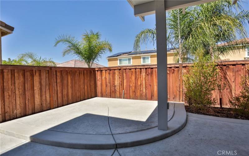 Back yard has a cement pad that could be used for a jacuzzi, plants, bbq etc.