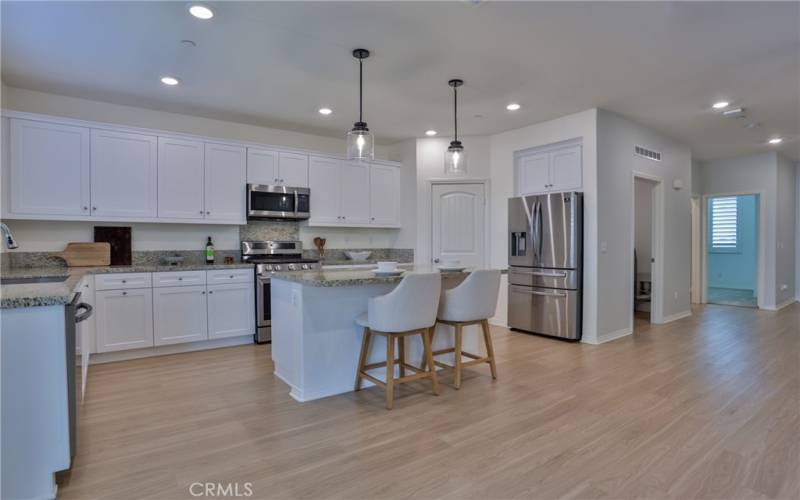 Ample storage and a walk in pantry. Beautiful granite countertops. The island has breakfast seating and storage underneath.