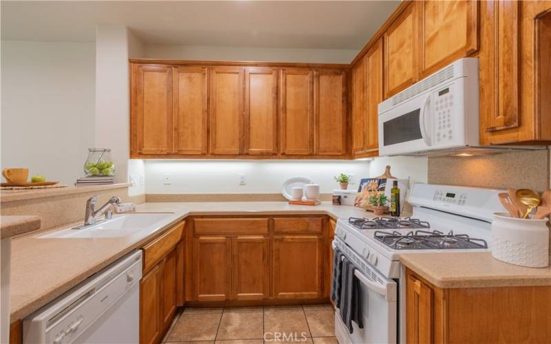 Lots of cabinets and hard surface counters in this kitchen