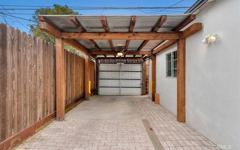 Private carport is gated and covered with direct access from alley.