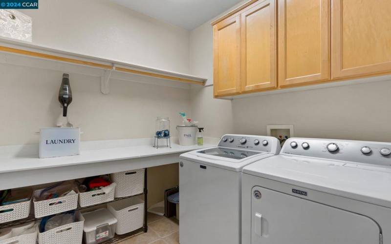 Laundry Room With Cabinetry & Folding Counter