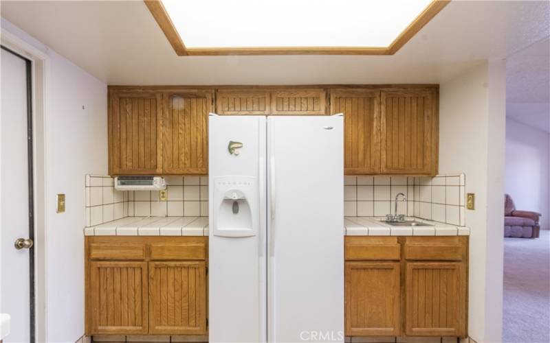 Extra prep sink and a refrigerator which remains with this home