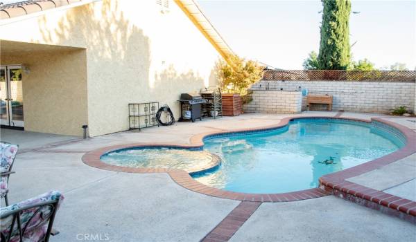 Built in pool and spa completely surrounded by a private block wall.  To the left is the large rear patio.