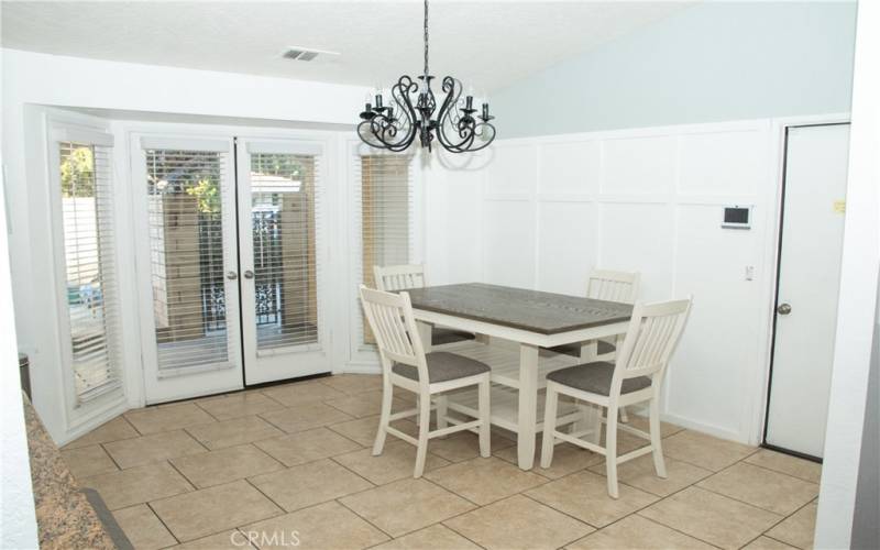 Large dining area next to the kitchen with double doors to the rear patio.