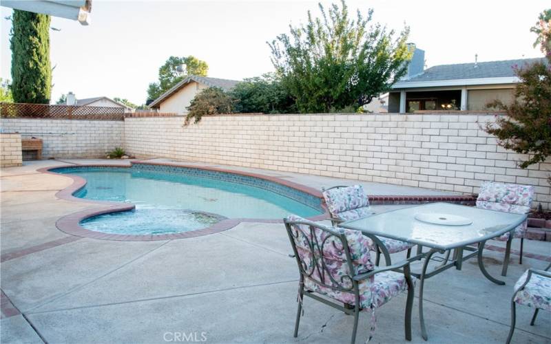 Built in pool and spa completely surrounded by a private block wall.  To the left is the large rear patio.