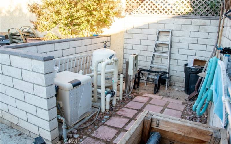 Pool equipment hidden behind a wall.