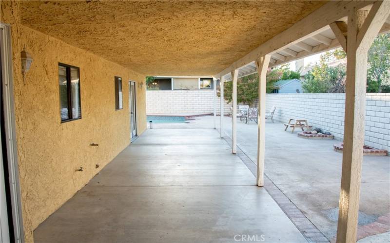 Large rear patio next to the pool.