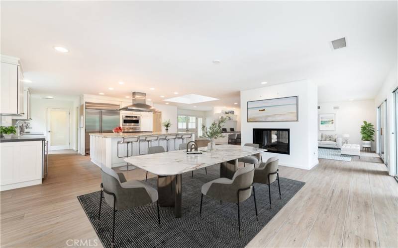 View of the dining room and bright kitchen with a huge island.