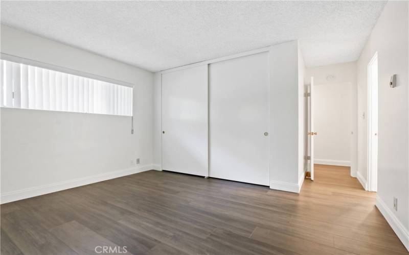 Primary bedroom with attached bath and enclosed patio