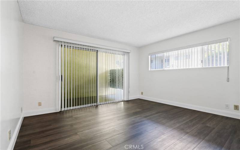 Primary bedroom with attached bath and enclosed patio