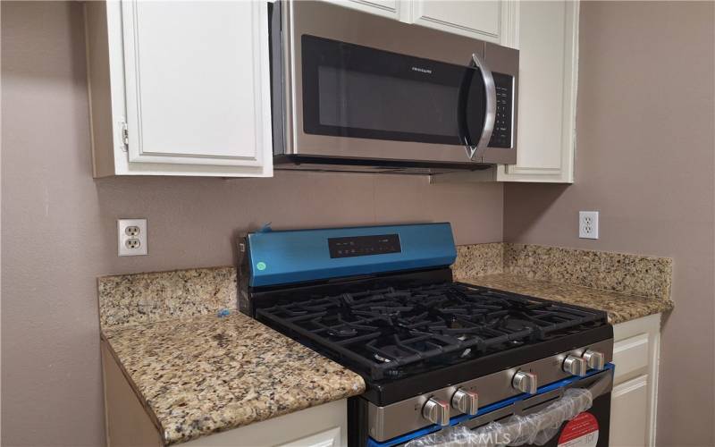 New stainless steel microwave and gas stove